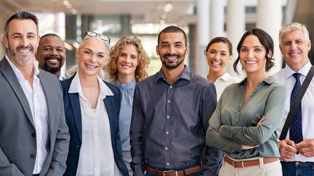 An image of a diverse group of smiling employees.